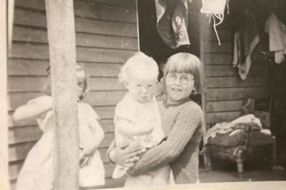Sally Treveton’s grandmother as a child in the 1950s, holding a cousin. Her father tried to hide the family’s Aboriginality.