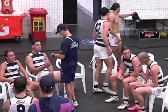 The Channel Seven cameras captured Tom Hawkins looking at a phone in the rooms during the weather break in Monday’s game.