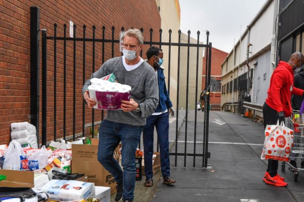 Deputy lord mayor Arron Wood helping collect donations at a North Melbourne mosque during the hard lockdown of high-rise housing towers in July.