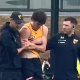 Will Day in the hands of trainers at Hawks training after injuring his shoulder.