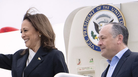 Vice President Kamala Harris, left, and second gentleman Douglas Emhoff descend from Air Force Two at Delaware Air National Guard Base in Delaware.