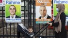 A woman turns up to the Merrylands East public school to vote with her baby in the local council elections.