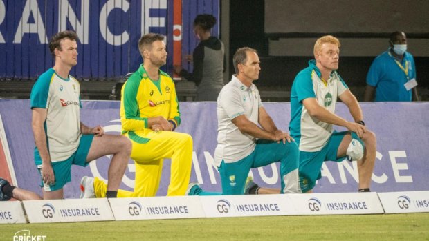 The Australian team takes a knee before their T20 clash with the West Indies.