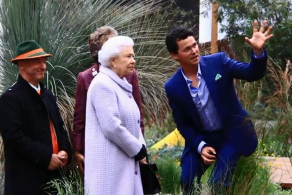 Phillip Johnson (right) and collaborator Wes Fleming show the Queen around their Chelsea Flower Show exhibit in 2013.