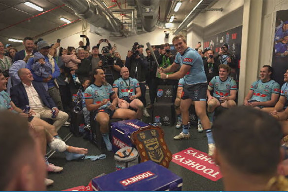 Rugby league nice guy Jake Trbojevic swings a baseball bat in front of his Blues brothers in a Suncorp Stadium dressing room. 