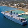 The Australian navy ship docks in Tonga to unload aid supplies.