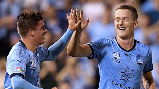 Dream come true: Cameron Devlin high-fives Brandon O'Neill for setting him up with his maiden A-League goal.