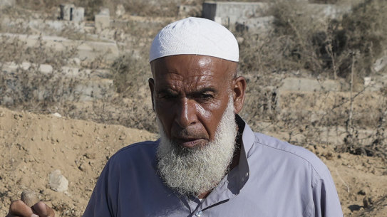 Palestinian grave digger Sa’di Baraka pauses while digging new graves in a cemetery in Deir al-Balah, Gaza Strip.