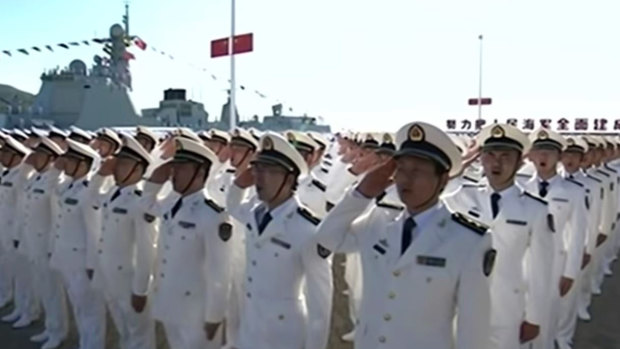 Sailors salute the Chinese President at the launch of the Shandong, China's first home-built aircraft carrier, last year.