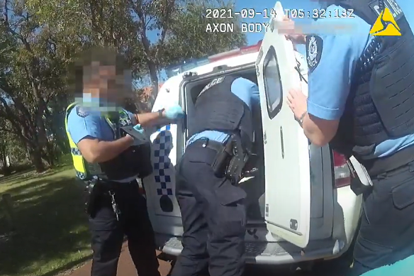 Body-worn camera footage shows the officer reaching into the van to repeatedly punch the man.
