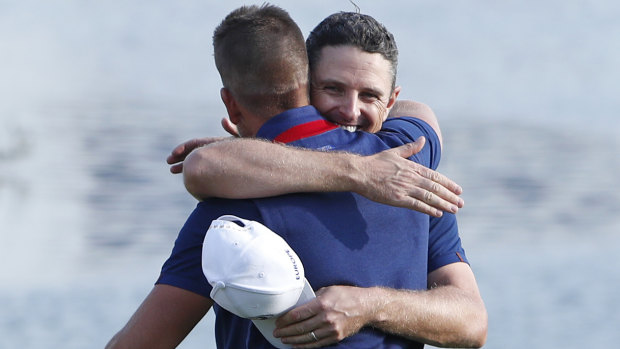 On top: Justin Rose, right, embraces Henrik Stenson after their win.
