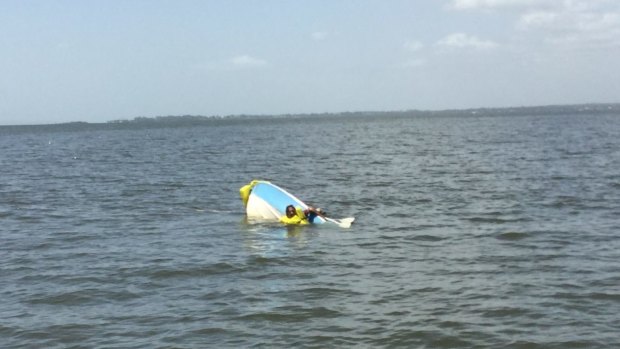 The fisherman was spotted clinging to his upturned boat on Thursday morning.