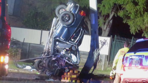 Four people were trapped in this vehicle after it collided with a power pole in Girraween. 