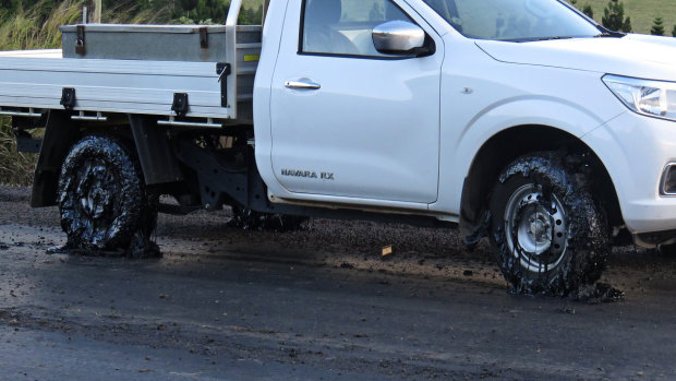A ute's tyres are caked in tar after driving on the Millaa Millaa-Malanda Road.