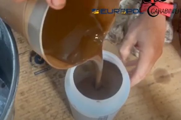 A dark liquid being poured in a video released by Europol.