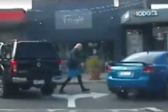 A screenshot of Rex Hunt walking towards a car at Beaumaris on Tuesday. 