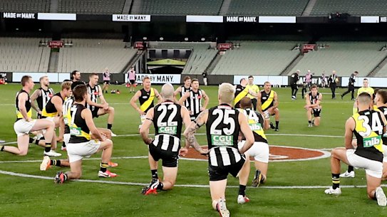 Taking the knee, as Collingwood and Richmond did at this AFL game in June, has become so commonplace that not taking it is now arguably the more overtly political gesture.