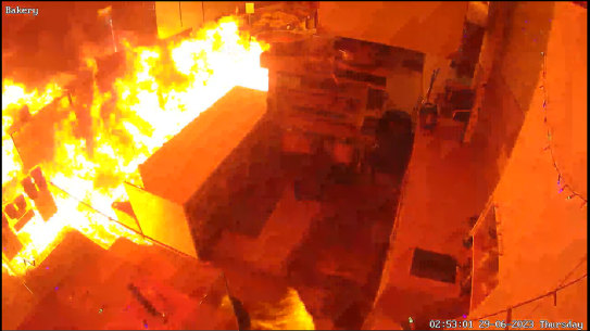 Video grab of fire igniting and filling the business with smoke and flames at Sonsa Market. 