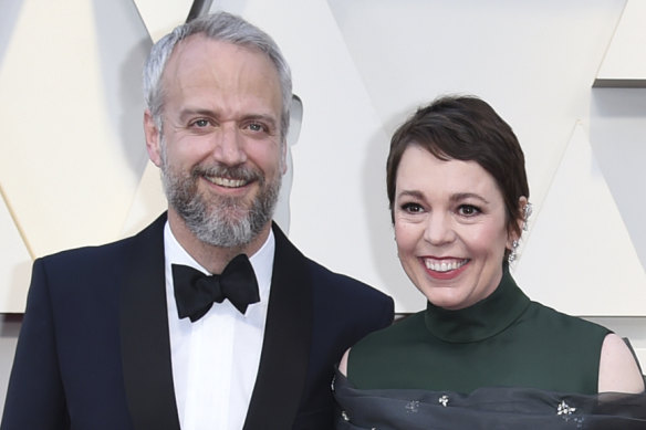 Olivia Colman and her husband Ed Sinclair arrive at the Oscars in February 2019. 