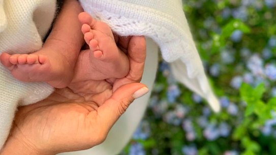 Meghan, the Duchess of Sussex, holds the feet of baby Archie Harrison Mountbatten-Windsor.