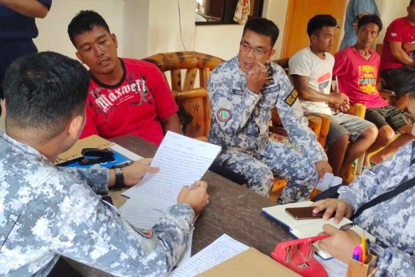 Filipino fishermen and coast guards after the incident in waters off Scarborough Shoal in the South China Sea. 