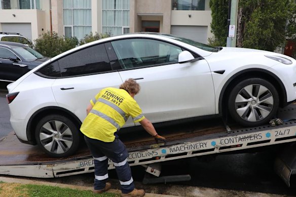 A Tesla is seized by police.