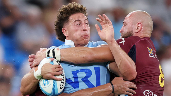Mark Nawaqanitawase of the Waratahs is tackled during the round three Super Rugby Pacific match against the Highlanders
