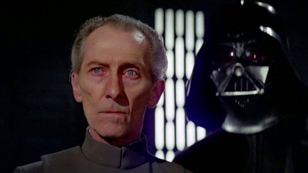 Peter Cushing as Grand Moff Tarkin in the original Star Wars, flanked by Darth Vader.