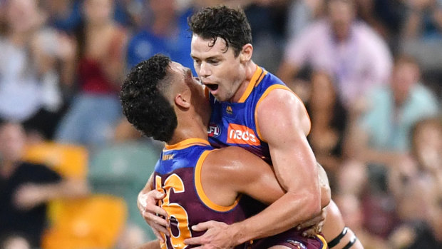 Lachie Neale and Cam Rayner celebrate a round-one goal.