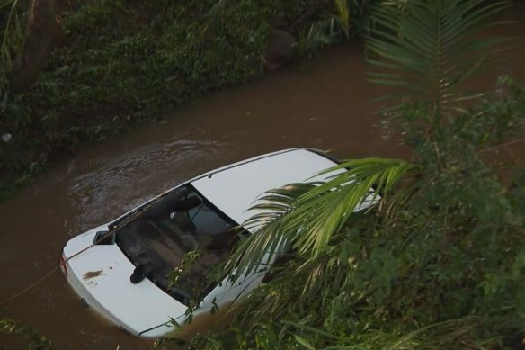 The man and woman’s car was swept into floodwaters near Lucan Avenue, Aspley. 