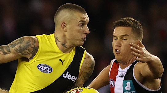 Dustin Martin brushes off two Saints.