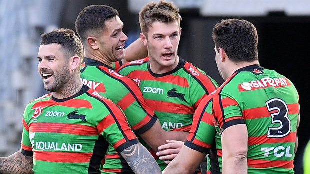 Back to winning ways: Campbell Graham celebrates with teammates after scoring for Souths at ANZ Stadium. However, it was Adam Reynolds, left, who sealed the victory.