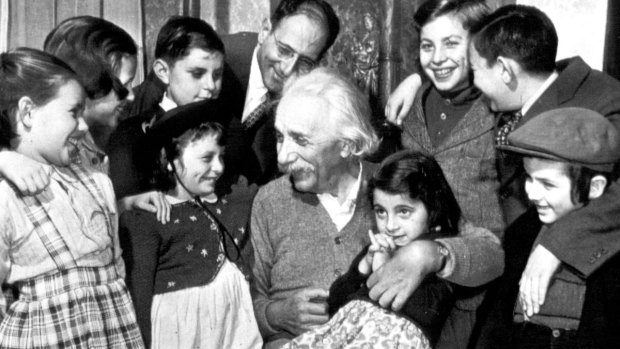 Displaced migrant children from a shelter visit Einstein for his 70th birthday in New York in 1949.