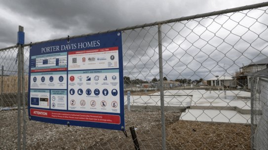 Amber-lea Drinnan and husband Dion Drinnan, standing on the concrete slab of their new home.