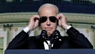 President Joe Biden puts on sunglasses after making a joke about becoming the “Dark Brandon” persona during 2023’s White House Correspondents’ Association dinner at the Washington Hilton.