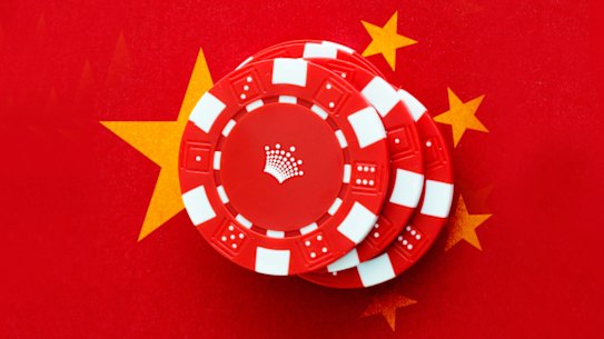 Crown chips sit on a Chinese flag on red felt.<br />
Digital image by Richard Giliberto.</p>
<p>Chian Crown illo</p>
