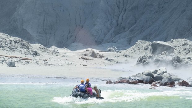 People being rescued after a volcano erupted on White Island off New Zealand's North Island.