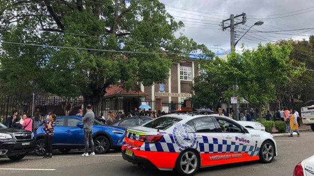 Police surround Eastwood Public School after a car crashed into the front fence on Thursday afternoon. 