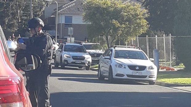 Armed police circle St Helena Secondary School in Eltham.