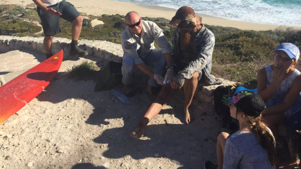 Jason Longgrass, 41, is treated by paramedics the second shark attack in Gracetown.