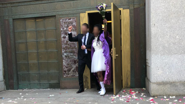A couple, who do not want to be identified, celebrates after their wedding for immigration purposes in New York.