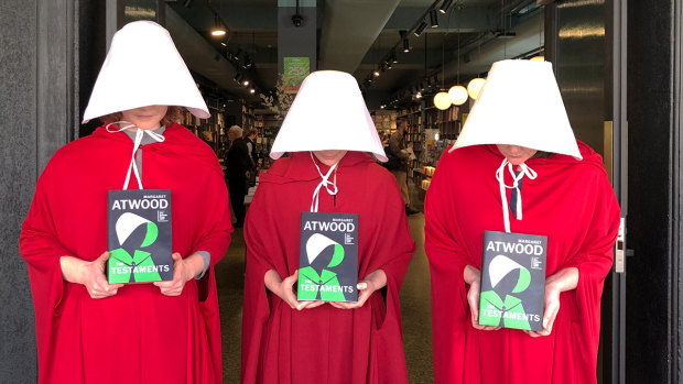 Three Readings staff members in Carlton, Melbourne, will be dressed as handmaids for the launch of Margaret Atwood's sequel, The Testaments, on Tuesday. 