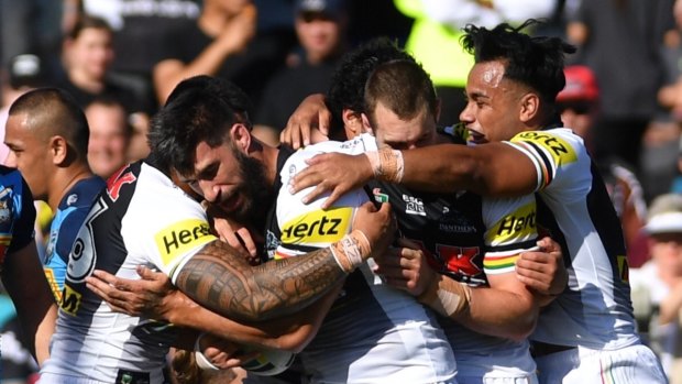 Barging run: The Panthers celebrate after James Tamou scores for the home side.