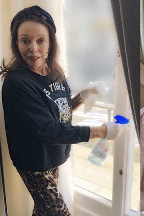 Dame Joan Collins getting stuck into the housework during the pandemic.