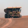 Autonomous haul trucks travels along a haul road at Rio Tinto Group’s Gudai-Darri iron ore mine.