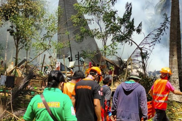 Rescuers search for survivors aafter Sunday’s crash.