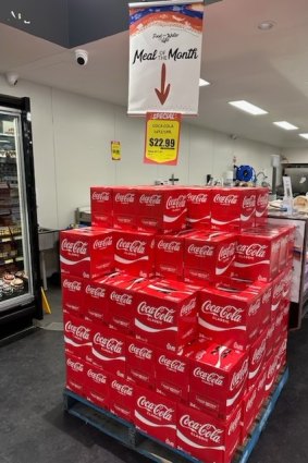 Boxes of Coca-Cola promoted as a “Meal of the Month” in a Walgett store.