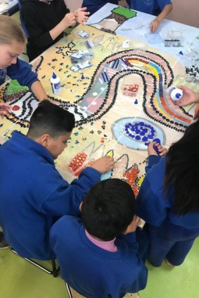 Children at St Georges Road Primary School in Shepparton making a mosaic from the painting they created for the Dunggula digital touch book.  