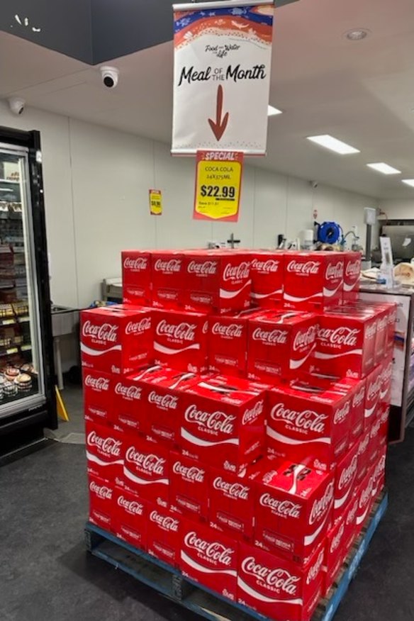 Boxes of Coca-Cola promoted as a “Meal of the Month” in a Walgett store.