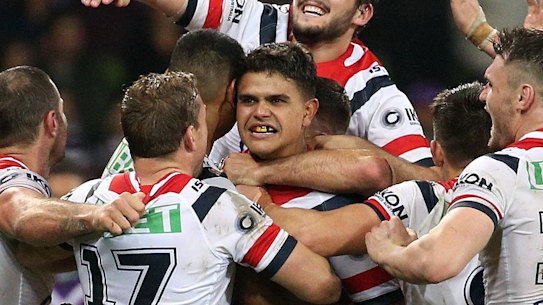 The power of one: Latrell Mitchell (centre) is mobbed by teammates after the final play.